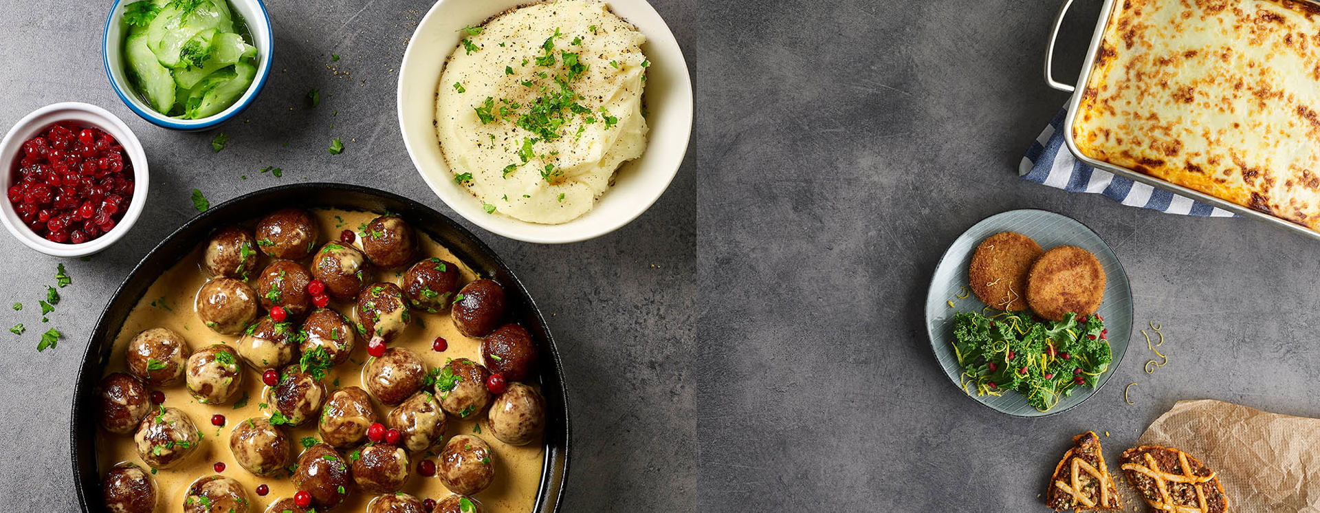 Dafgårds maträtter serverade på bord med köttbullar, potatismos, gratäng och tillbehör som visar brett sortiment av färdiglagad mat