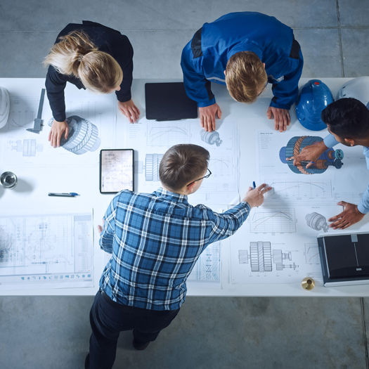 Stock Photo Team Of Industrial Engineers Lean On Office Table Analyze Machinery Blueprints Architectural 1902078616
